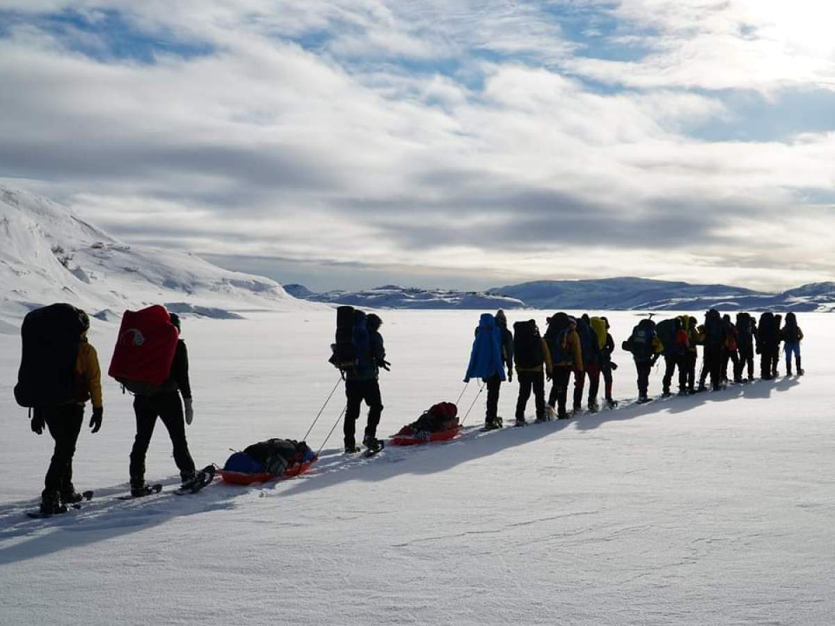 a group of people cross country skiing in the snow